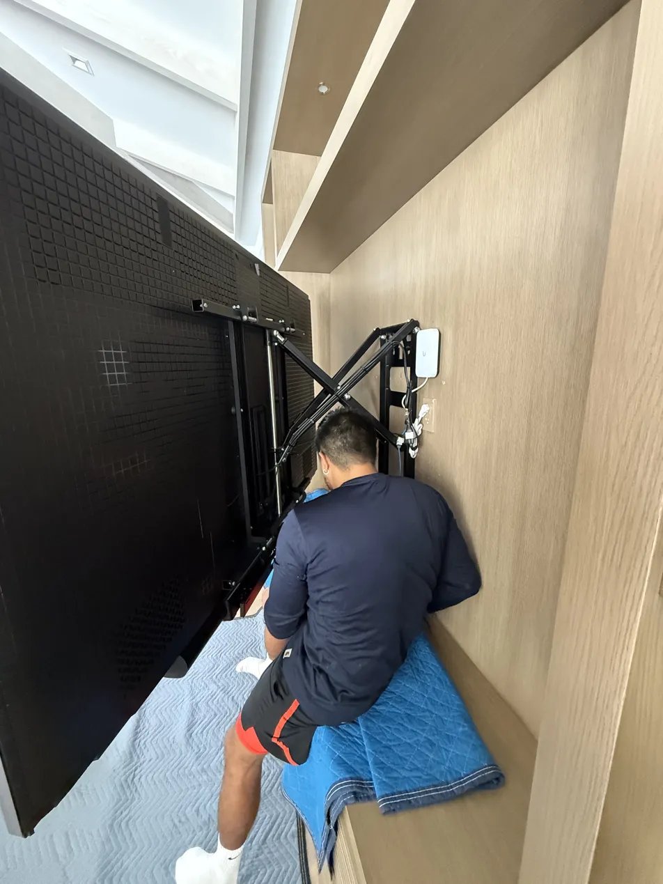 Klenova technician installing TV mount
